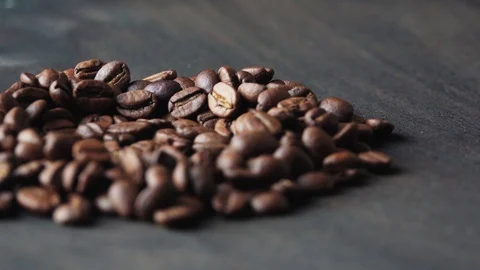 Coffee beans spin on a dark background Stock Footage 119579094