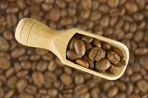 Coffee beans in spoon Stock Photos