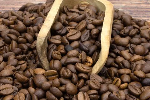 Coffee beans in a spoon Stock Photos
