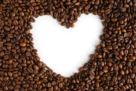 Coffee Beans Surface with Heart Shaped Negative Space Stock Photos