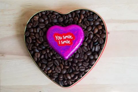 Coffee beans surrounded Chocolate wrapper on Valentine's Day, Wood background Stock Photos