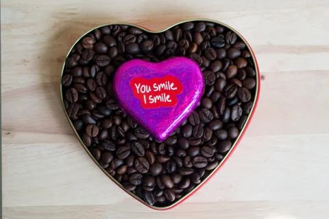 Coffee beans surrounded Chocolate wrapper on Valentine's Day, Wood background Stock Photos