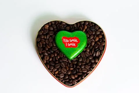 Coffee beans surrounded Chocolate wrapper on Valentine's Day, Wood background Stock Photos