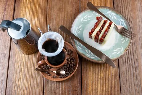Coffee beans surrounded by cup, filter cloth and guava sweet and curd cheese. Stock Photos
