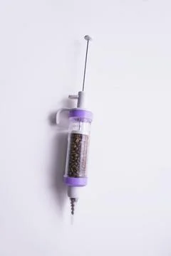 Coffee beans in a syringe Stock Photos