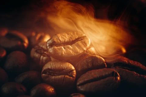 Coffee beans on the table fried with steam and hot close-up Photos