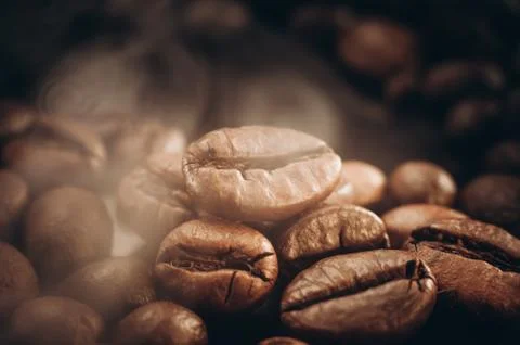 Coffee beans on the table fried with steam and hot close-up Fotos Stock