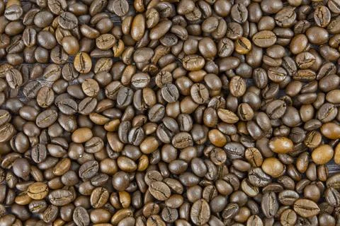 Coffee beans on the table. Texture of coffee beans. Stock Photos