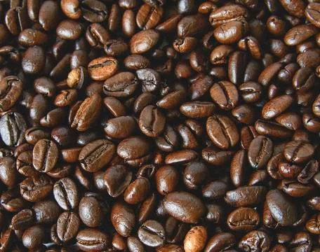 Coffee beans texture. Coffee background.  Close-up of coffee background. Stock Photos