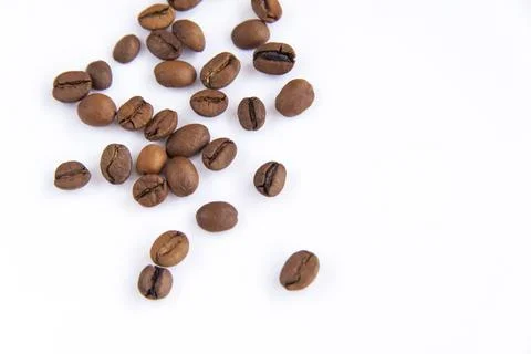 Coffee beans on a white background. Roasted coffee beans. Stock Photos