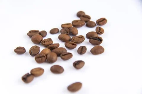 Coffee beans on a white background. Roasted coffee beans. Stock Photos
