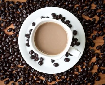 Coffee beans with white coffee cup . Stock Photos