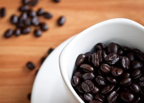 Coffee beans with white coffee cup . Stock Photos