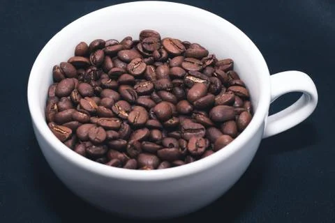 Coffee beans in white cup Stock Photos