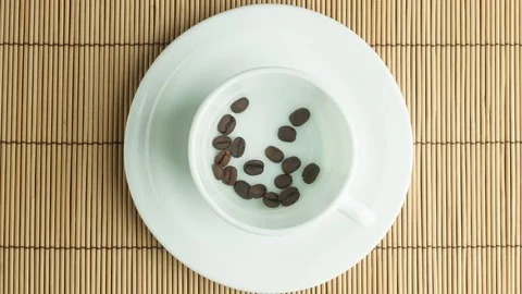 Coffee beans in a white cup stop motion Stock Footage 103501203