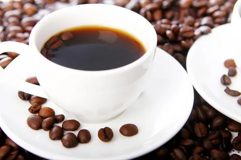 Coffee beans with white cups Coffee beans with white cups on the table ,mo... Stock-Fotos