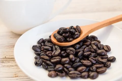 Coffee beans on the white dishware Stock Photos