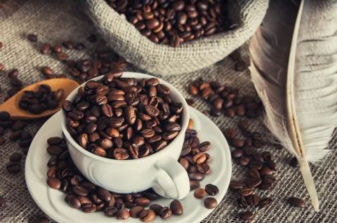 Coffee beans in white mug Stock Photos