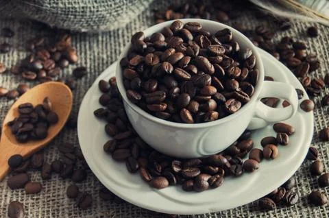 Coffee beans in white mug Stock Photos