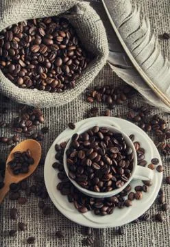 Coffee beans in white mug Stock Photos