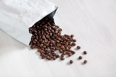 Coffee beans in white package on white background Foto stock