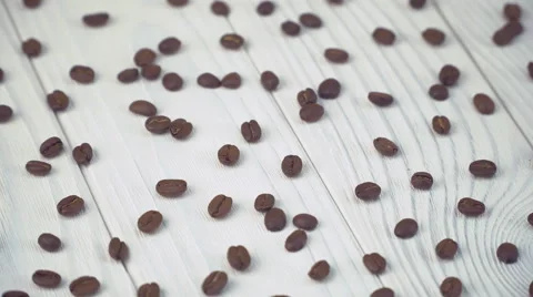 Coffee beans on a white wooden table. Video stock 62956664