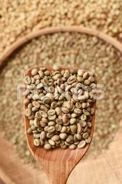 Coffee beans on wooden spoon Stock Photos