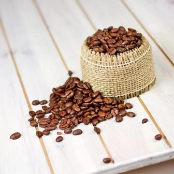 Coffee beans on wooden table Stock Photos