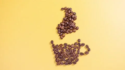 Coffee beans on a yellow background Video stock 142195636