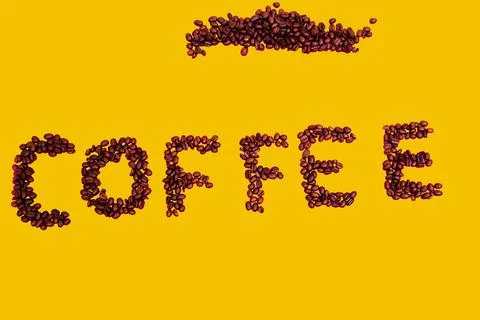 Coffee beans on yellow Stock Photos
