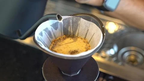 Coffee being brewed in a coffee machine with dark background Stock Photos