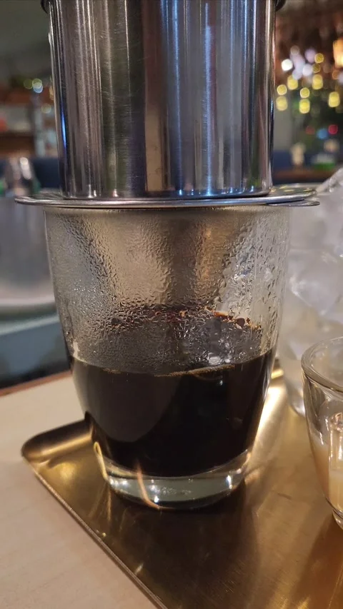 Coffee being brewed through a Vietnamese drip filter Stock Footage 323496821