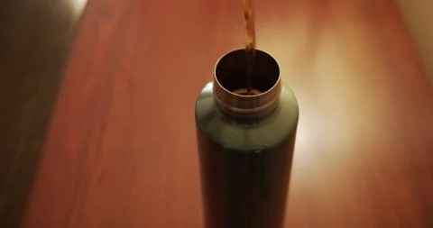 Coffee being poured into a metal to-go thermos Stock Footage 229639953