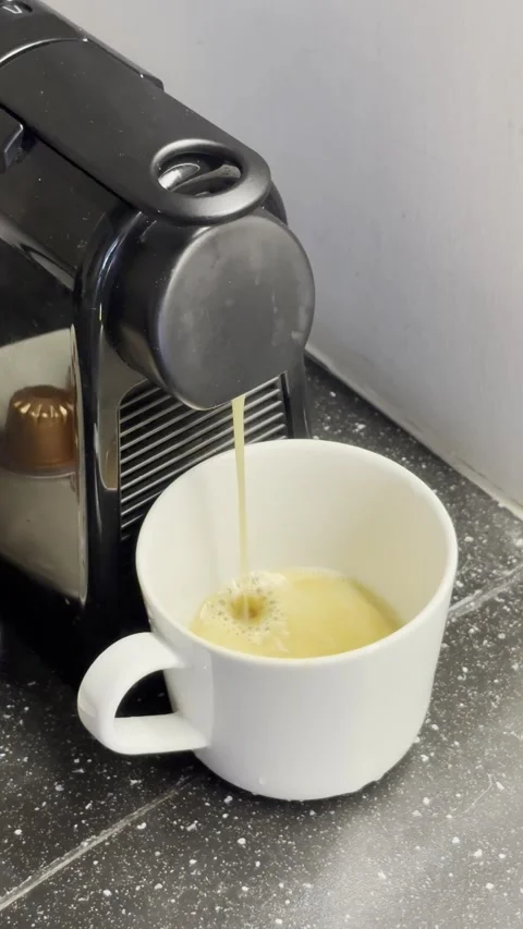 A coffee being poured from a modern coffee machine into a mug Stock Footage 318725908