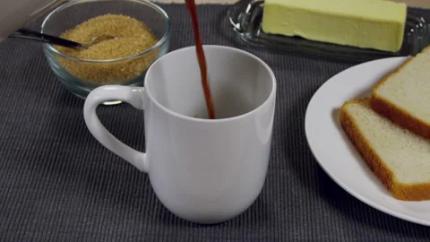 Coffee Being Poured Next To Buttered Toast On a Plate Stock Footage 243415697