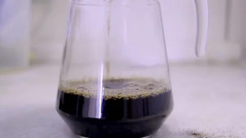 COFFEE BEING POURED INTO TRANSPARENT JAR Stock Footage 150337471