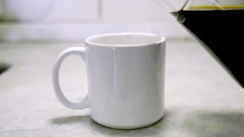 COFFEE BEING POURED INTO WHITE CUP Stock Footage 150337466
