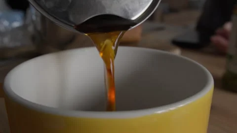 Coffee Being Poured into a Yellow Mug Stock Footage 285566588