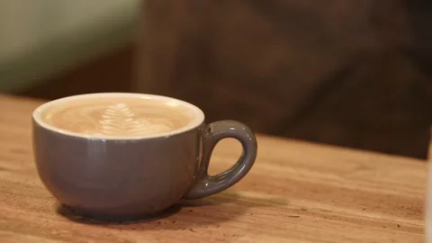 Coffee being put down on table Stock Footage 245467933