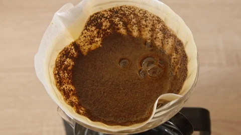 Coffee bloom in cone paper filter Stock Footage 120995199
