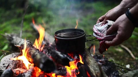 Coffee is boiling on the campfire. Video stock 60580645