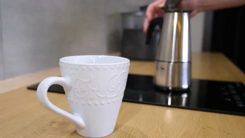 Coffee boils in a geyser coffee maker at home in the kitchen Stock Footage 168572052