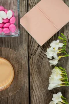 Coffee, book, flowers and easter eggs on wooden table Stock Photos