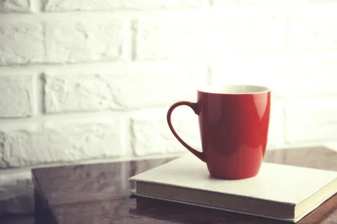 Coffee on book on table Stock Photos