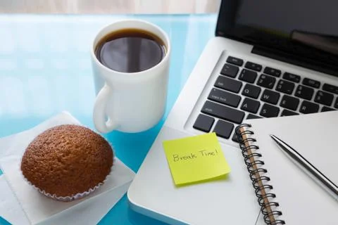 Coffee break and paper note with break time message stick on laptop Stock Photos