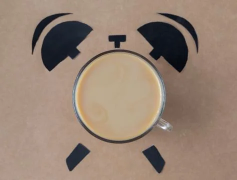 Coffee break concept. breakfast time concept. Coffe cup in shape of alarm clock Stock Photos