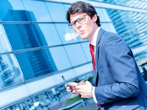 Coffee break with an electronic cigarette Stock Photos