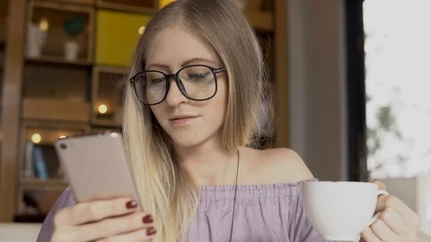 Coffee break. Female with smartphone while drinking coffee Stock Footage 85923224