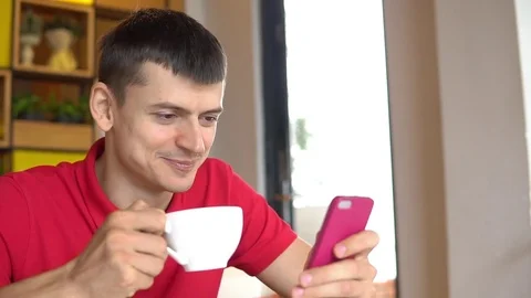 Coffee break. Man using cellphone while drinking coffee Stock Footage 85339978