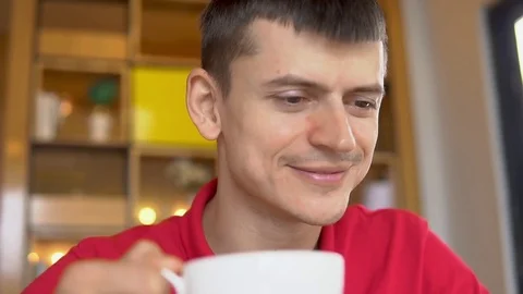 Coffee break. Man using smartphone while drinking coffee Video stock 84492415